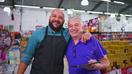 Two employees of Grocery store posing for camera, Brazilian workforce of supermarket, senior manager with staff