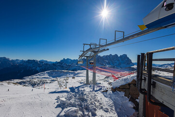 Falcade, Italy - February 15, 2023: At a lift station in the mountains of the Dolomites. Skiers...