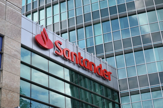 Santander bank signage, logo, emblem on the facade of Santander bank branch. POZNAN, POLAND - JULY 18, 2023