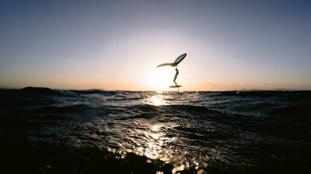 Wingsurfer having evening foil session in Red Sea, Egypt.
