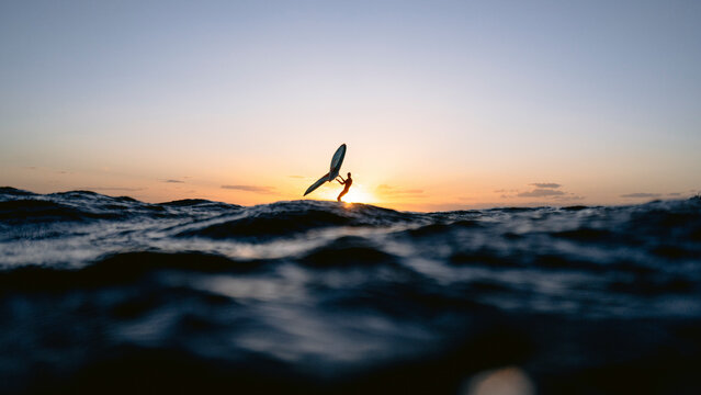 Wingsurfer having evening foil session in Red Sea, Egypt.