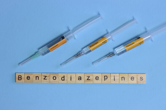 Benzodiazepines in tree syringe in a light blue background. Midazolam, lorazepam and diazepam