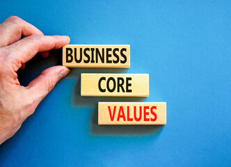 Business core values symbol. Concept words Business core values on wooden block. Beautiful blue table blue background. Businessman hand. Business motivational business core values concept. Copy space.
