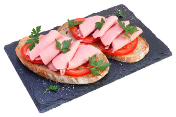 Two sandwiches on black slate board. Cooked meal isolated on white background. Mortadella sliced on tomatoes with rye bread and parsley. - 630085092