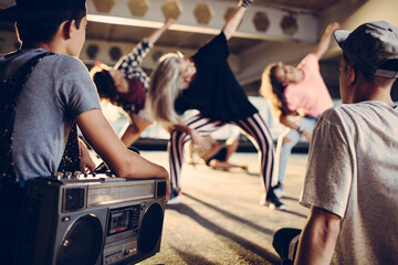 Young people break dancing in a parking lot