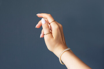 Woman hand posing showing her rings and jewellry