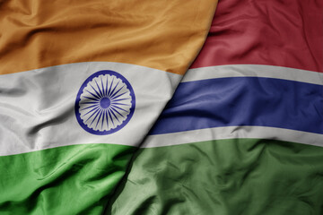 big waving realistic national colorful flag of india and national flag of gambia.