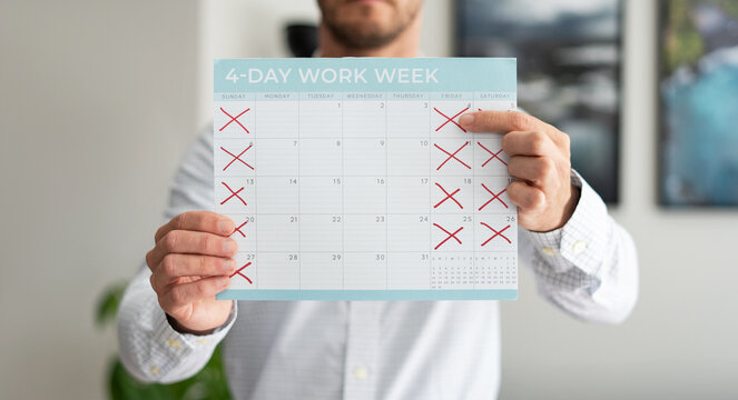A Man holding a Calendar with a Four Day Work Week Concept