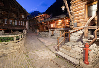 The rural architecture of Alagna village in the Valsesia valley range at dusk - Italy.