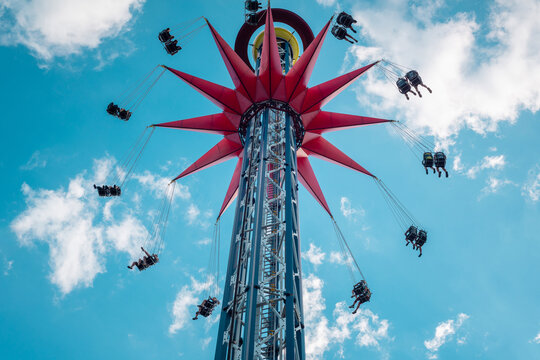 A spinning Extreme Attraction against the blue Sky in the Amusement Park of the city of St. Petersburg