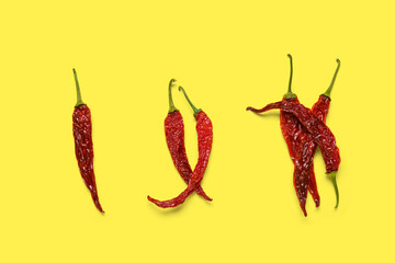 Dry hot chili peppers on yellow background