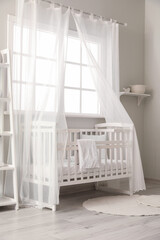Fototapeta na wymiar Interior of stylish children's bedroom with crib
