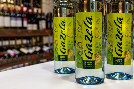 Bottles of Portugal white wine Gazela Vinho Verde close-up on blurred background of wine shelves. Ukraine, Zhytomyr, August, 1, 2023