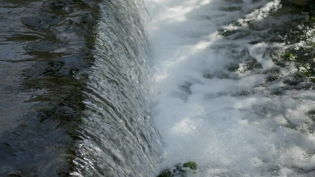 Dam closeup view with a waterfall in slow motion.