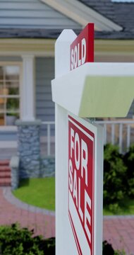 Vertical Pan and Zoom of Sold For Sale Real Estate Sign in Front of New House. No property release needed - this is a 3D rendering.