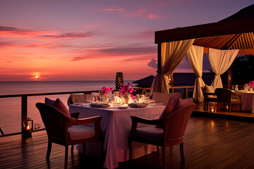A luxurious table is elegantly set for a romantic dinner against the backdrop of a breathtaking sunset sky and serene sea.