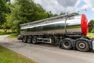 A truck tank of gasoline with reflection on the road