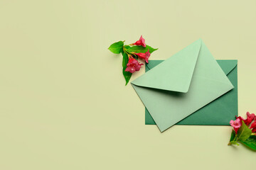 Composition with envelopes and flowers on color background