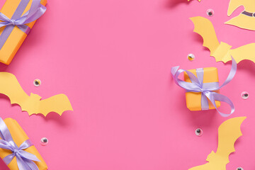 Composition with beautiful gift boxes and Halloween decor on pink background, closeup