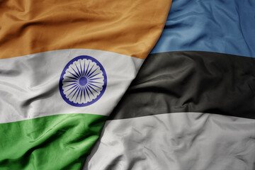 big waving realistic national colorful flag of india and national flag of estonia .