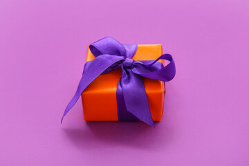 Beautiful gift box for Halloween on purple background