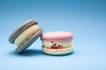 Two macaroons on blue background, french dessert and sweet food