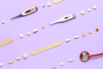 Composition with pills, stethoscope and digital thermometers on pink background