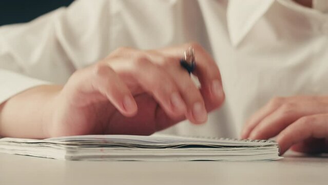 Schizophrenia patient doing a psychological test in a psychiatric clinic. Writing doodle in notebook nervously , shaking hands, tremor. Psychiatry patient hands close up , macro.