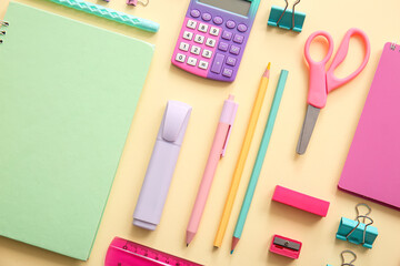Different school stationery and notebooks on beige background