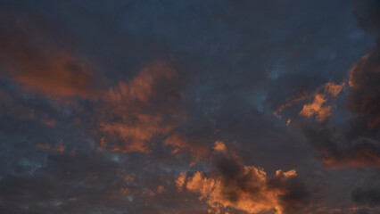 Fluffy orange clouds illuminated by the light coming from the setting sun. Pure nature untouched by...