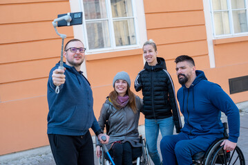 Four friends with disabilities taking selfie