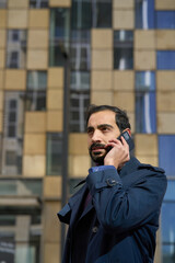 Muslim businessman talking on mobile phone. Arab businessman talking on mobile phone