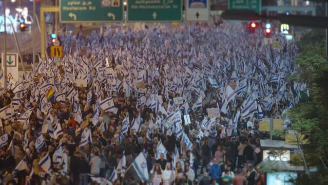 Thousands of people wave Israeli flags during demonstrations