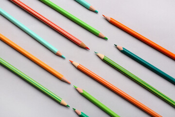 Composition with different pencils on light background, closeup