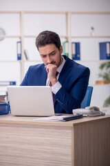 Fototapeta premium Young male employee and too much work in the office