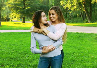 Fototapeta premium portrait of mother and daughter hugging, summer time, park