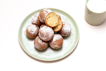 Flatly Fat Thursday Carnival or Tlusty Czwartek, Christian tradition. Zeppole Or Paczki On Plate With Powdered Sugar, Cup Of Milk On Table. Doughnut, Delicious Donuts. Horizontal Plane