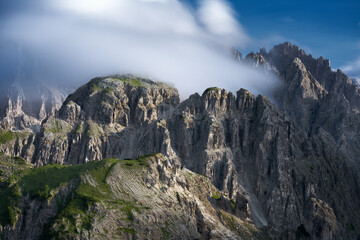Beautiful mountain rocky peaks lit by beautiful sun and blue sky. Dolomites, Italy
