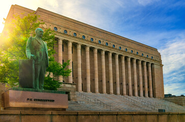 Parliament house of Finland with Svinhufvud statue in front of it and nice sun lighting. 