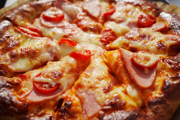 close-up. Pizza with ham, cheese and tomatoes. 