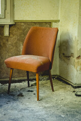 Fototapeta na wymiar an upholstered chair in a dilapidated house