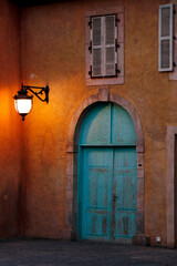 front view of and Authentic old house with wooden door and glass window, hanging light on the wall