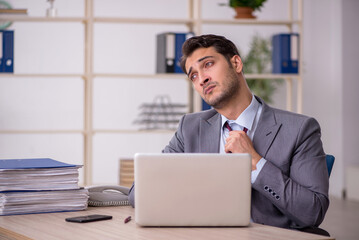 Young male employee working in the office