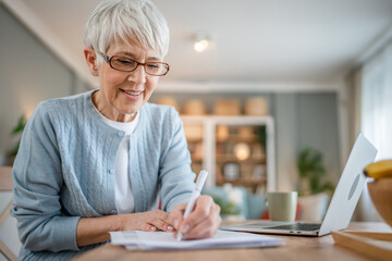 Senior caucasian woman use laptop computer at home for work
