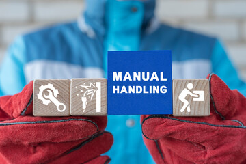 Worker or welder holding colorful blocks with icons and inscription: MANUAL HANDLING. Concept of manual handling. Right and Wrong Manual Handling, Welding, Repair and Lifting of Heavy Goods.