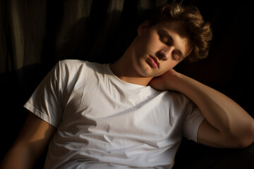 portrait of a young man with white t-shirt sleeping peacefully. High quality photo