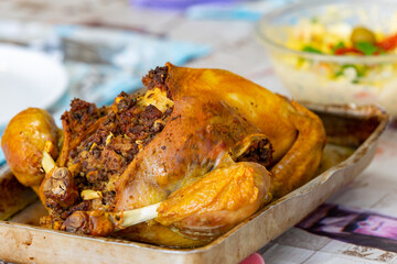 Traditional homemade mayonnaise salad with roasted chicken stuffed with Brazil-style farofa