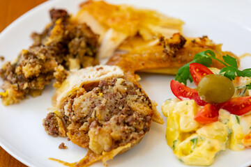 Traditional homemade mayonnaise salad with roasted chicken stuffed with Brazil-style farofa