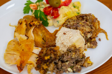 Traditional homemade mayonnaise salad with roasted chicken stuffed with Brazil-style farofa