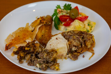 Traditional homemade mayonnaise salad with roasted chicken stuffed with Brazil-style farofa